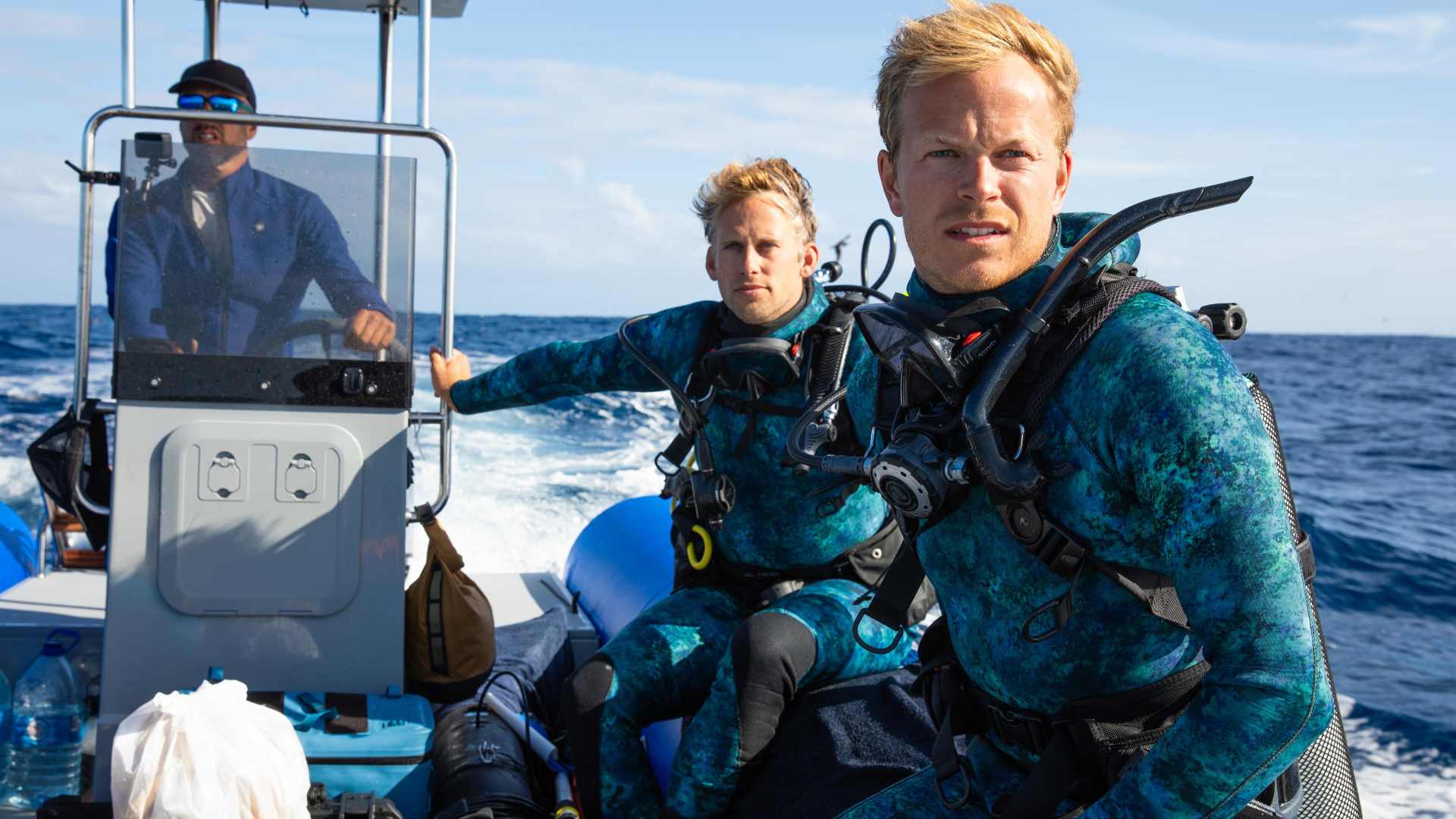 Bertie Gregory in diving gear on a canoe