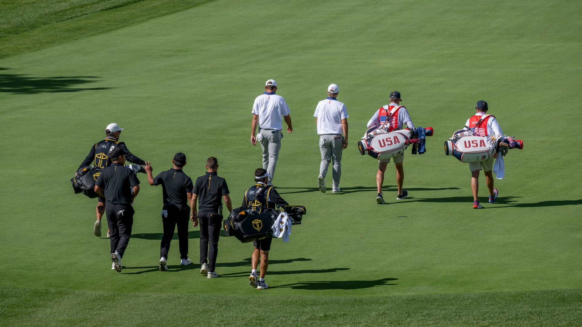 Two golf teams walk on the course
